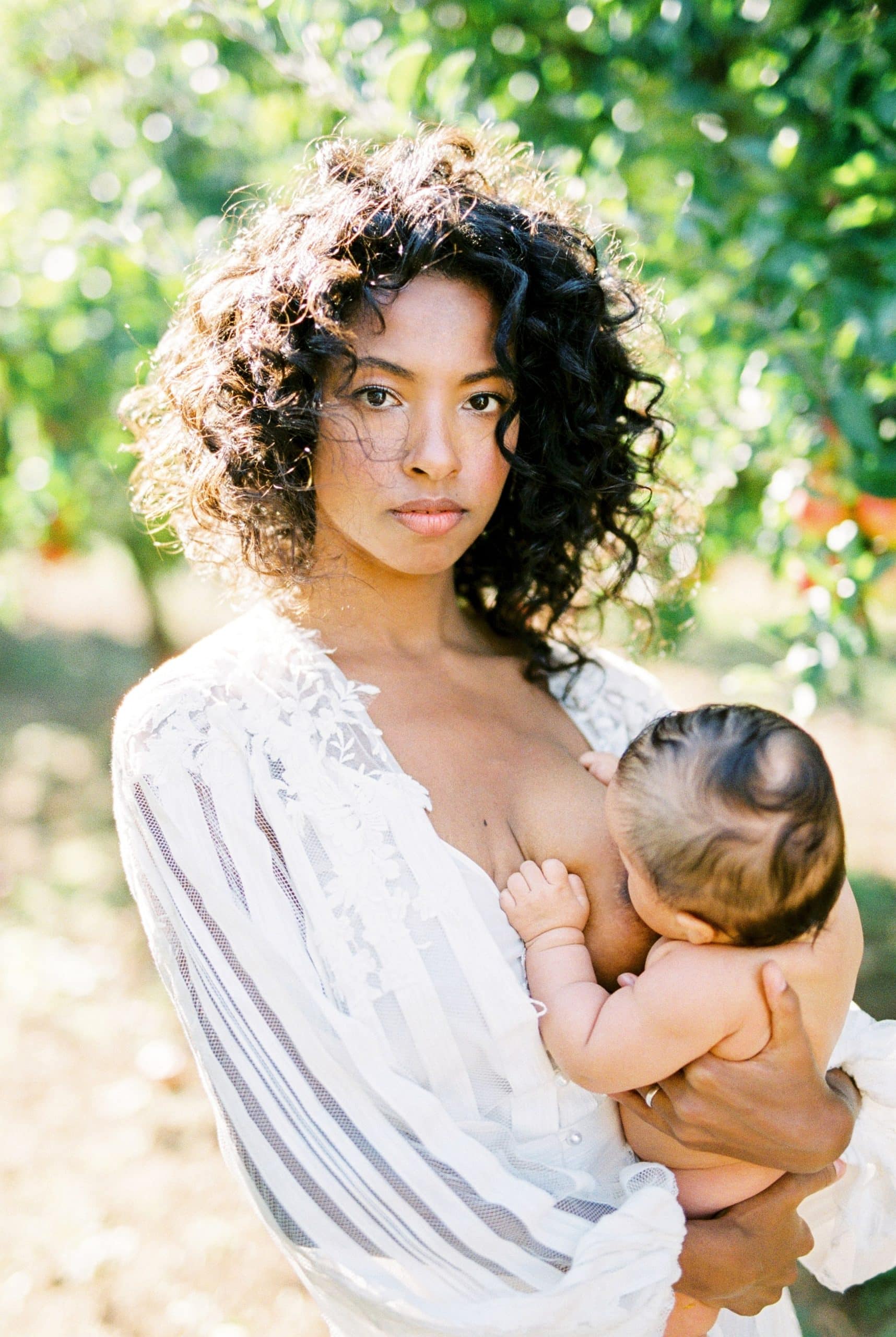 woman-in-white-dress-breastfeeding-her-newborn-bab-2023-11-27-05-23-59-utc