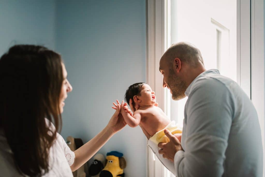 newborn baby at home with parents
