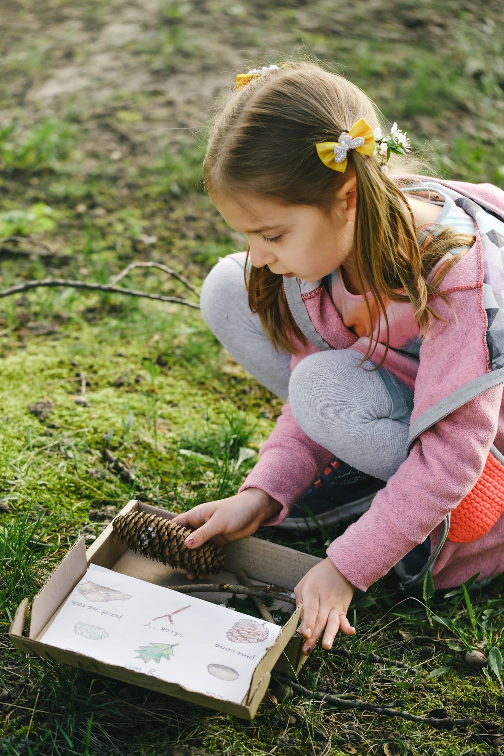 girl doing a nature scavenger hunt